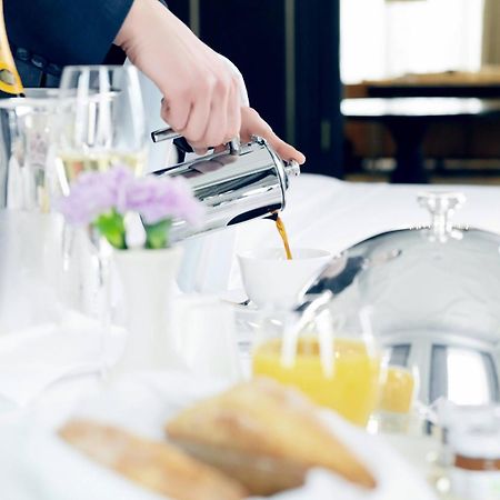 The St. Regis Astana Hotel Exterior foto A server pouring orange juice