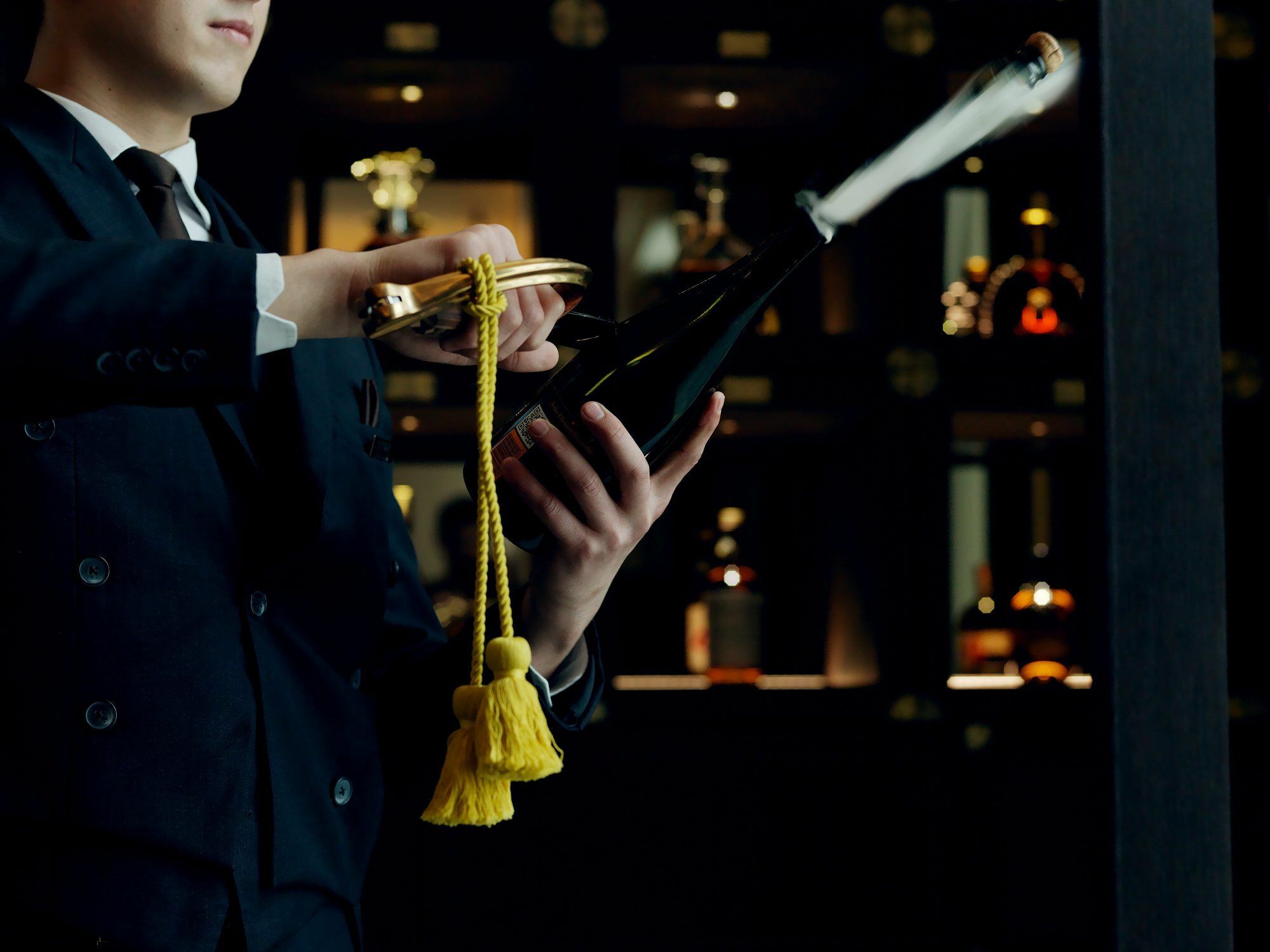 The St. Regis Astana Hotel Exterior foto A wine waiter opening a bottle of wine